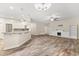 Open concept living area featuring a fireplace, built-in bookshelves, and wood-look tile flooring at 917 Southern Oak Ln, Apopka, FL 32712