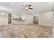 Spacious living room featuring wood-look tile flooring, neutral walls and an open floor plan at 917 Southern Oak Ln, Apopka, FL 32712