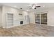 Spacious living room boasting wood look tile, a fireplace, built in cabinets and access to the pool at 917 Southern Oak Ln, Apopka, FL 32712