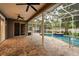 A screened in pool area with brick pavers, ceiling fans, and a jacuzzi at 917 Southern Oak Ln, Apopka, FL 32712