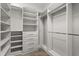 Walk-in closet featuring built-in shelving and drawers, and wood-look tile flooring at 917 Southern Oak Ln, Apopka, FL 32712