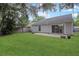 Expansive backyard features a lush lawn and a sliding glass door leading to a patio for outdoor entertaining at 1026 Mccully Ct, Oviedo, FL 32765