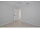 Bedroom with neutral walls, tile floor, and white ceiling fan with window and door to bathroom at 1026 Mccully Ct, Oviedo, FL 32765