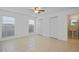 Bright bedroom with ceramic tile flooring, ceiling fan, and two windows with blinds at 1026 Mccully Ct, Oviedo, FL 32765