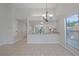 Open-concept dining area with tile flooring and modern lighting, adjacent to the kitchen and living spaces at 1026 Mccully Ct, Oviedo, FL 32765