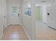 Bright entryway leading to an open kitchen with tile floors and access to the backyard at 1026 Mccully Ct, Oviedo, FL 32765