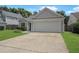Well-maintained home with a two-car garage, lush green lawn, and classic suburban charm at 1026 Mccully Ct, Oviedo, FL 32765