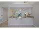 Open kitchen with granite countertops and pass-through, ideal for entertaining and Gathering gatherings at 1026 Mccully Ct, Oviedo, FL 32765