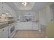 Well-lit kitchen featuring white cabinetry, appliances, and an open layout for easy living at 1026 Mccully Ct, Oviedo, FL 32765