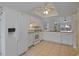 Well-lit kitchen showcases white appliances and cabinetry, offering a clean and functional cooking space at 1026 Mccully Ct, Oviedo, FL 32765