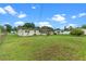 Expansive backyard with lush lawn and mature trees offering ample space for outdoor activities at 110 N Sunland Dr, Sanford, FL 32773