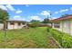 Spacious backyard with a shed, grill, partial fence and partial landscaping at 110 N Sunland Dr, Sanford, FL 32773