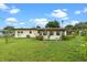 Well kept backyard features mature trees and lush landscaping at 110 N Sunland Dr, Sanford, FL 32773