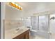 A well-lit bathroom with a large mirror, a vanity with wood accents, and a shower/tub combo with sliding doors at 110 N Sunland Dr, Sanford, FL 32773