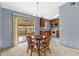 Cozy dining area featuring a wooden table set next to the kitchen with access to the sunroom at 110 N Sunland Dr, Sanford, FL 32773