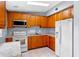 Well-equipped kitchen with stainless steel appliances, bright countertops, and natural wood cabinetry at 110 N Sunland Dr, Sanford, FL 32773