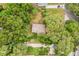 Aerial view showing the property's roof, surrounded by lush greenery and a driveway at 1212 N Hudson St, Orlando, FL 32808