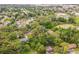 This aerial view shows the property surrounded by trees and greenery at 1212 N Hudson St, Orlando, FL 32808