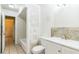 Bathroom featuring tile flooring, toilet, sink and vanity with decorative tiled wall and tub with shower at 1212 N Hudson St, Orlando, FL 32808