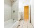 Bathroom with marble tile shower and tub and an open doorway to the vanity and toilet area at 1212 N Hudson St, Orlando, FL 32808