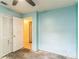 Bedroom with blue walls, ceiling fan and closet at 1212 N Hudson St, Orlando, FL 32808