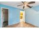 Bedroom with wooden flooring, blue walls, and doorways to the closet and next room at 1212 N Hudson St, Orlando, FL 32808