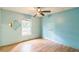Bedroom with wooden flooring, ceiling fan, and an open window at 1212 N Hudson St, Orlando, FL 32808