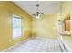 Dining room area with tile flooring, a window, and an outdated hanging light at 1212 N Hudson St, Orlando, FL 32808