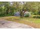 View of the home and a sprawling front yard shaded by mature trees at 1212 N Hudson St, Orlando, FL 32808