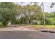 Exterior view of home from the street with mature trees at 1212 N Hudson St, Orlando, FL 32808