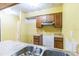 Kitchen with wooden cabinets, dual basin sink, and needs some TLC at 1212 N Hudson St, Orlando, FL 32808