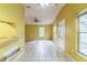 Empty living room with large tiled floor, entrance door and a window view at 1212 N Hudson St, Orlando, FL 32808