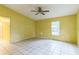 Empty living room with large tiled floor and a window view at 1212 N Hudson St, Orlando, FL 32808