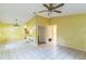 The spacious living room features a ceiling fan, an open layout, and access to other areas at 1212 N Hudson St, Orlando, FL 32808