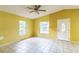Bright living room with tiled floors, ceiling fan, and ample natural light from multiple windows at 1212 N Hudson St, Orlando, FL 32808