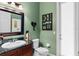 Stylish bathroom features a granite countertop, dark wood cabinets, and decor touches at 1224 Northern Way, Winter Springs, FL 32708