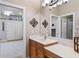 Bathroom vanity features wood cabinets, quartz countertop, modern fixtures, large mirror, and great lighting at 1224 Northern Way, Winter Springs, FL 32708