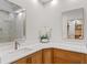 Bathroom featuring wood vanity with quartz countertop, double mirrors, and glass enclosed shower at 1224 Northern Way, Winter Springs, FL 32708