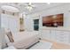 Bright bedroom with custom built-ins, desk, flat screen TV, ceiling fan and neutral decor at 1224 Northern Way, Winter Springs, FL 32708