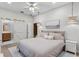 Bedroom features neutral decor, sliding barn door to bathroom, ceiling fan, and pendant lights at 1224 Northern Way, Winter Springs, FL 32708