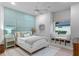 Charming bedroom with light green accent wall, ceiling fan, window seat with storage, and neutral decor at 1224 Northern Way, Winter Springs, FL 32708