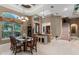 Elegant dining room with a glass table, chandelier, and large windows providing plenty of natural light at 1224 Northern Way, Winter Springs, FL 32708