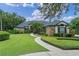 Charming home with stone accents, lush landscaping, and a winding walkway to the front door at 1224 Northern Way, Winter Springs, FL 32708