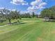 Scenic golf course view with lush green grass, mature trees, and blue skies at 1224 Northern Way, Winter Springs, FL 32708