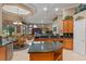 Spacious open-concept kitchen with granite countertops, wooden cabinets, and seamless transition to the living area at 1224 Northern Way, Winter Springs, FL 32708