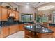 A well-equipped kitchen with granite countertops, wooden cabinets, and a view of the outdoor space at 1224 Northern Way, Winter Springs, FL 32708