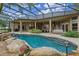 Back of the house features a screened pool, covered patio, and manicured landscaping at 1224 Northern Way, Winter Springs, FL 32708
