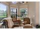 Cozy sitting area with comfortable armchairs and large windows offering scenic outdoor views at 1224 Northern Way, Winter Springs, FL 32708
