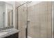 Modern bathroom with a tiled glass shower, granite counter tops and a large mirror at 1323 Wood Line Dr, Deland, FL 32720