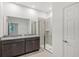 Bathroom featuring a granite countertop vanity, large mirror, and glass-enclosed shower at 1323 Wood Line Dr, Deland, FL 32720